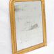 19th-century patinated mirror with a ribbon-style frame