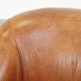 Very comfortable, elegant leather club armchair with a removable seat cushion and timeless design