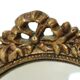 Miroir ovale vintage en résine dorée à la feuille d'or, style années 60. Classique.