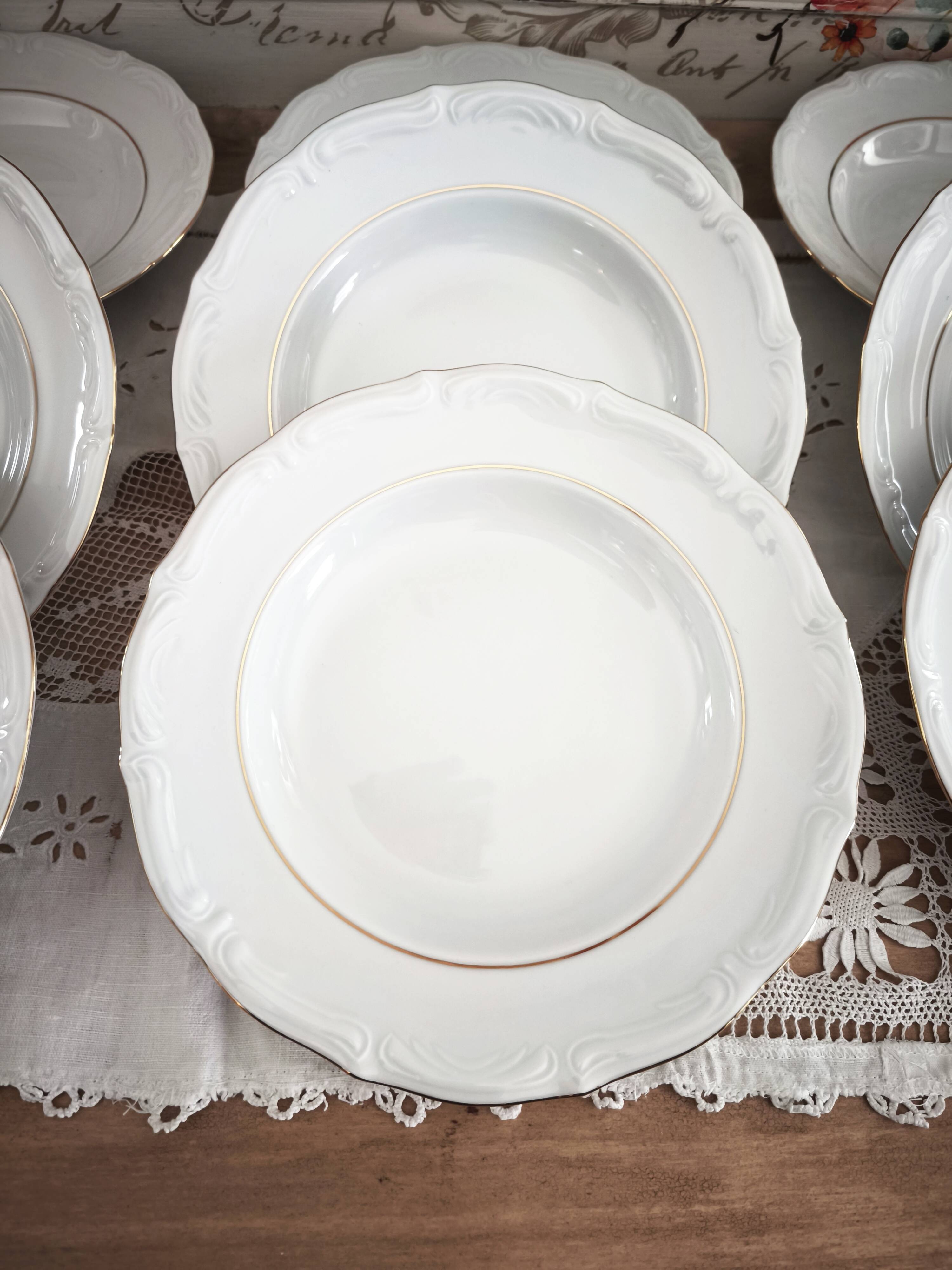 12 deep plates in porcelain with double gold trim.