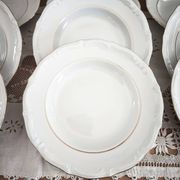 12 deep plates in porcelain with double gold trim.