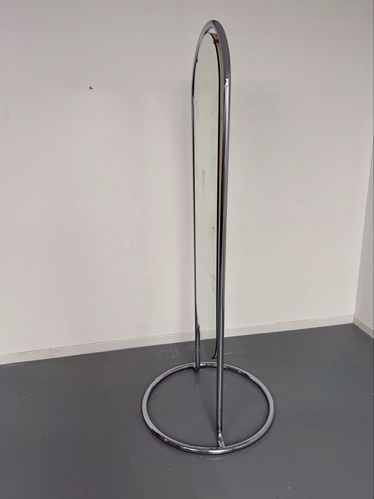 Large freestanding chrome metal full-length mirror in 1970s design.