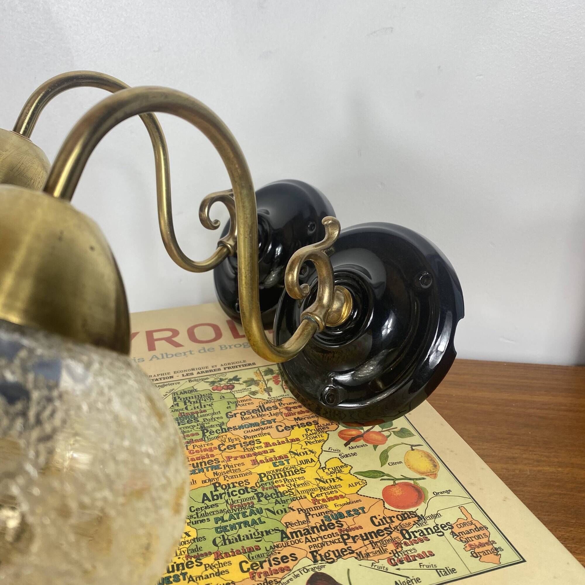 Pair of antique wall sconces in brass with tulip-shaped glass shades.