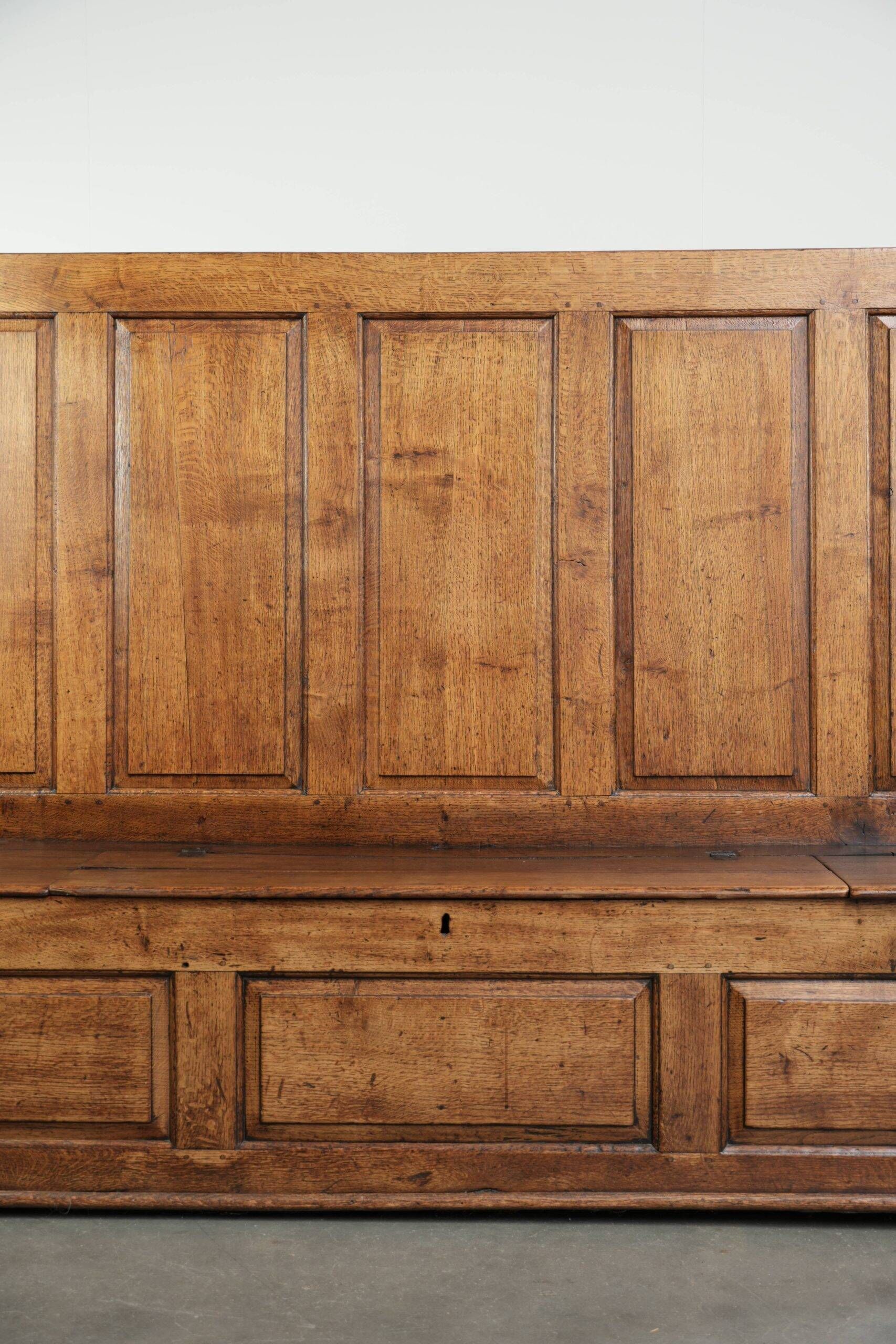 Antique English oak hall bench from the early 19th century with storage space