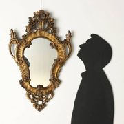 Antique Rococo-style mirror, gilded linden decorations, 20th century.