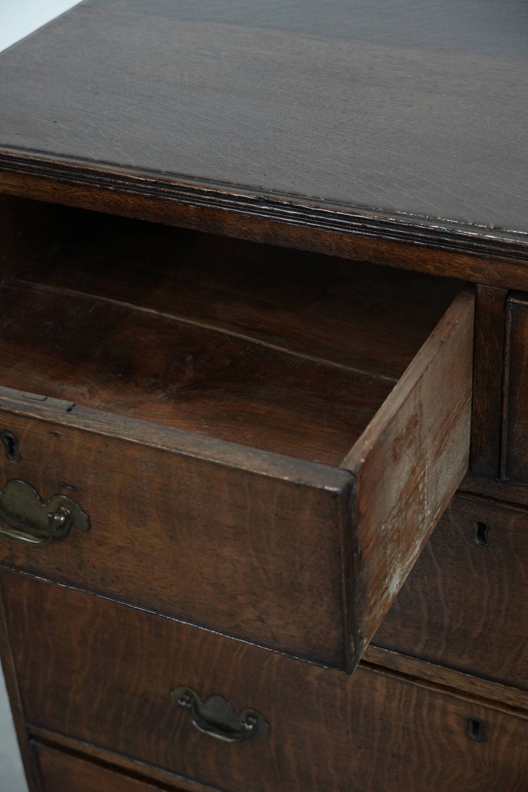 Antique English oak commode dating from the late 18th century.