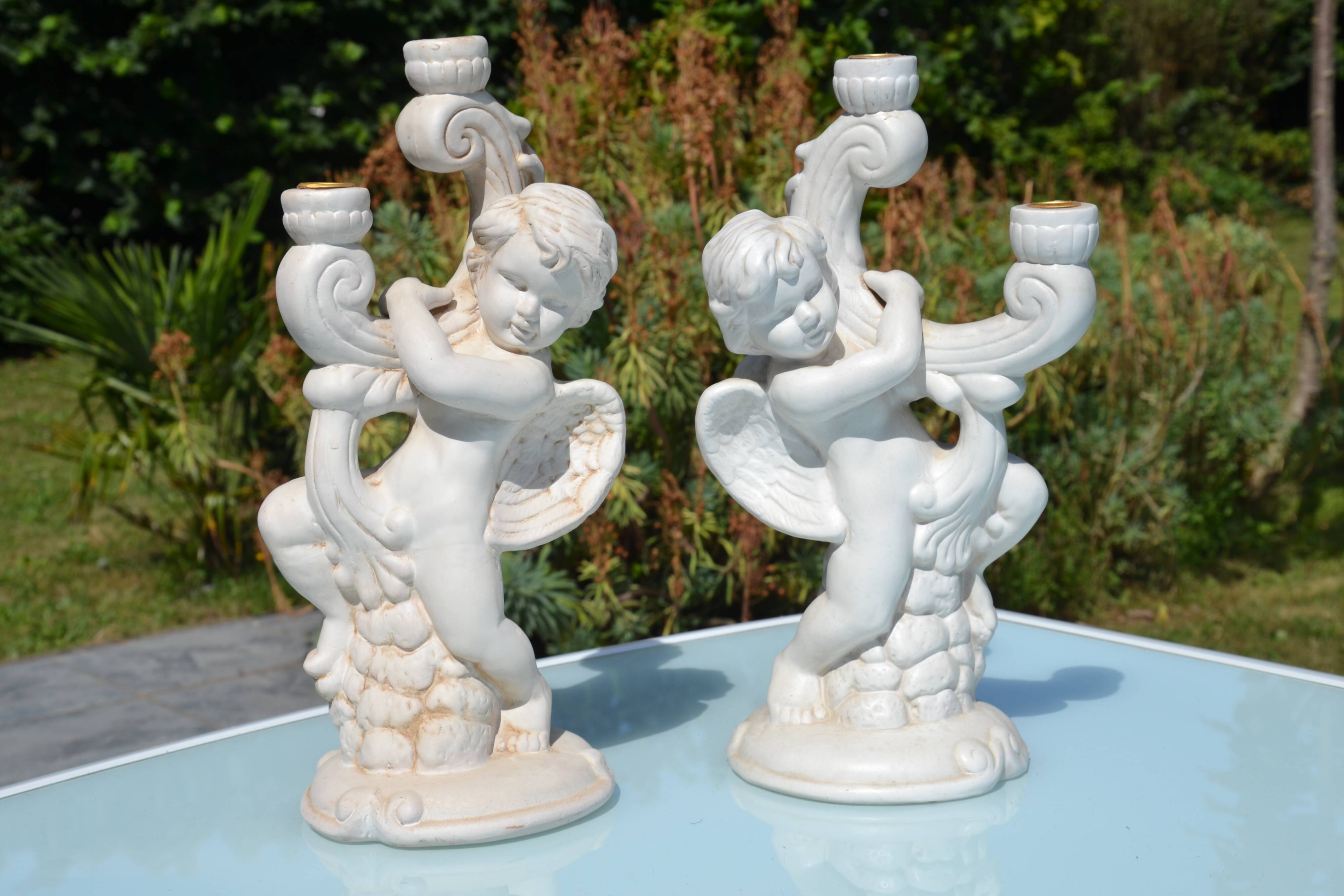 Pair of "cherub" candle holders in plaster