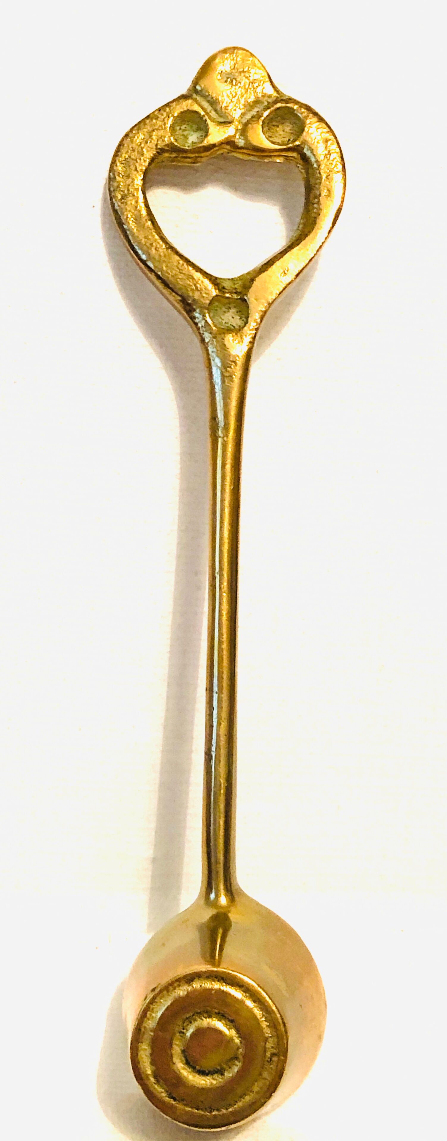 Antique candle extinguisher in golden brass