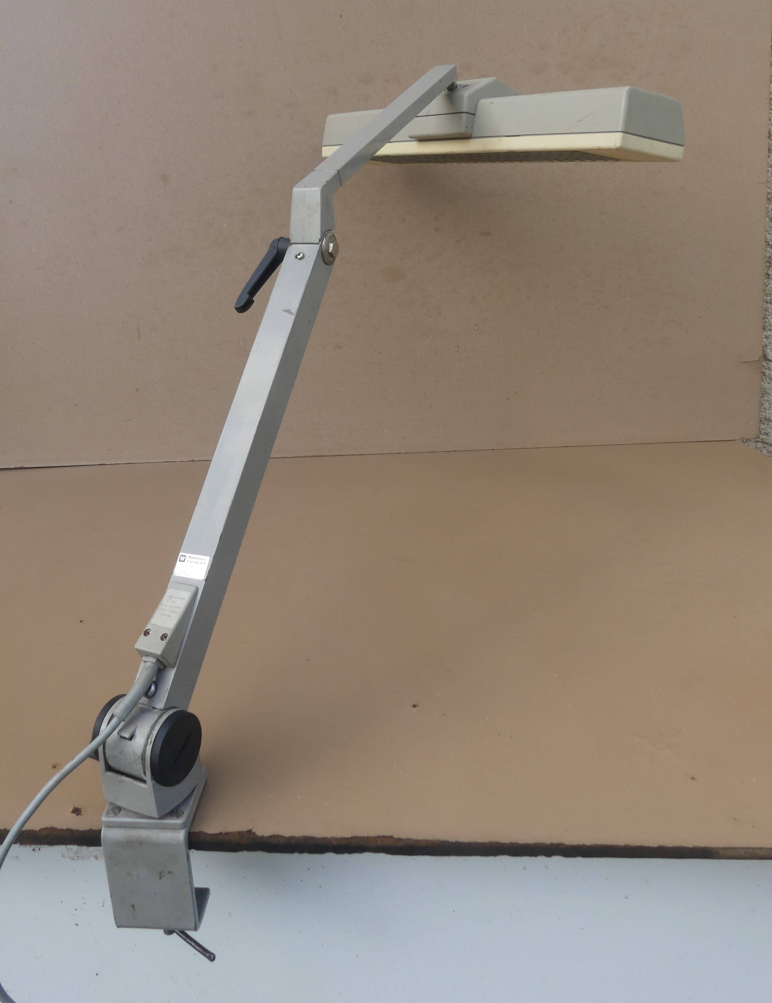 WALDMANN articulated workshop lamp with two industrial clamp arms for architects.