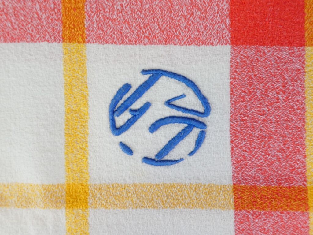Old tablecloth and 11 towels crossed red blue