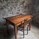 Old French table in cherry wood with bistro chair, circa 1900–1930.