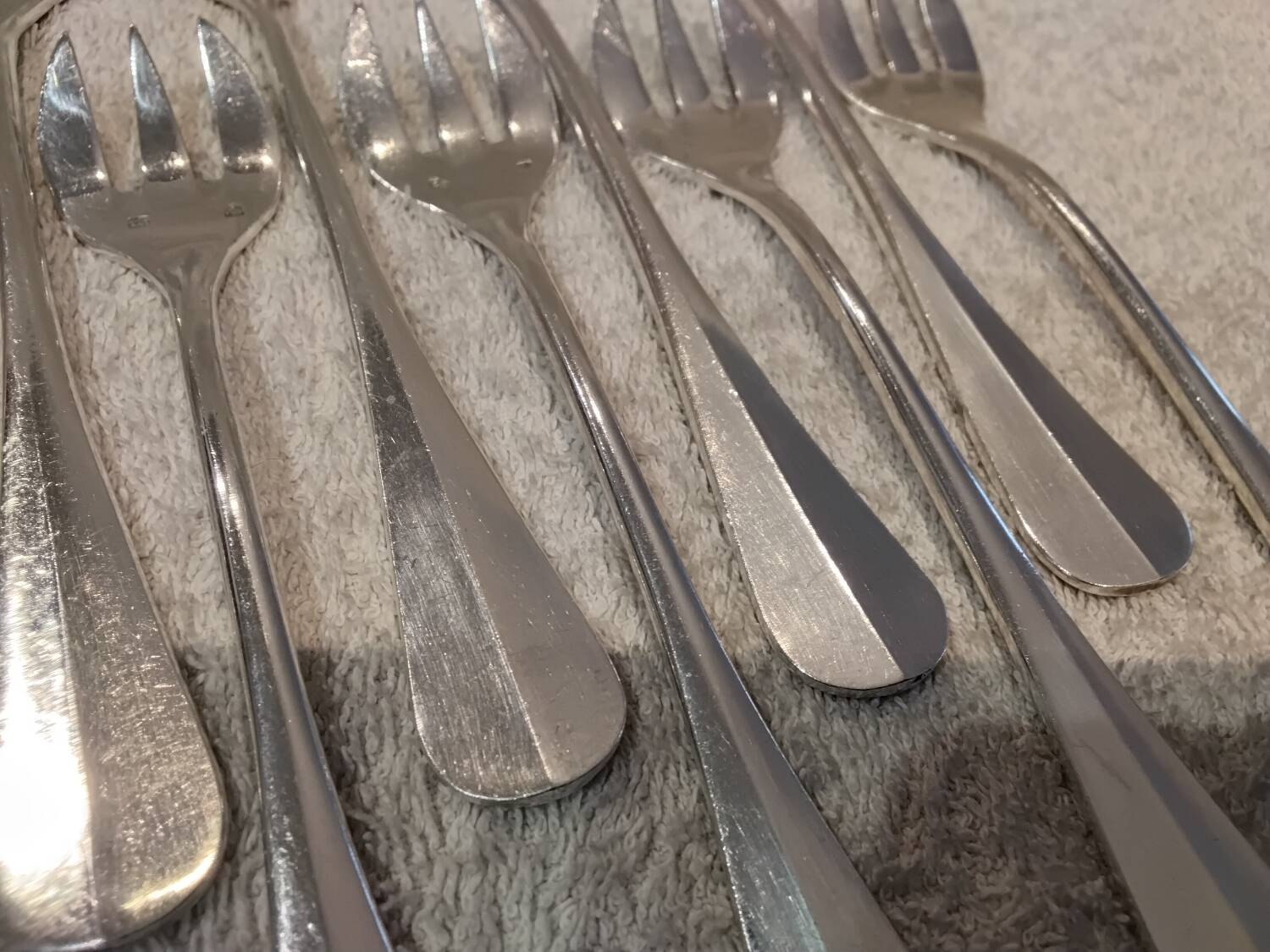 12 silver-plated oyster forks by silversmith J Brille with stick handles.