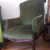 Old green velvet armchair