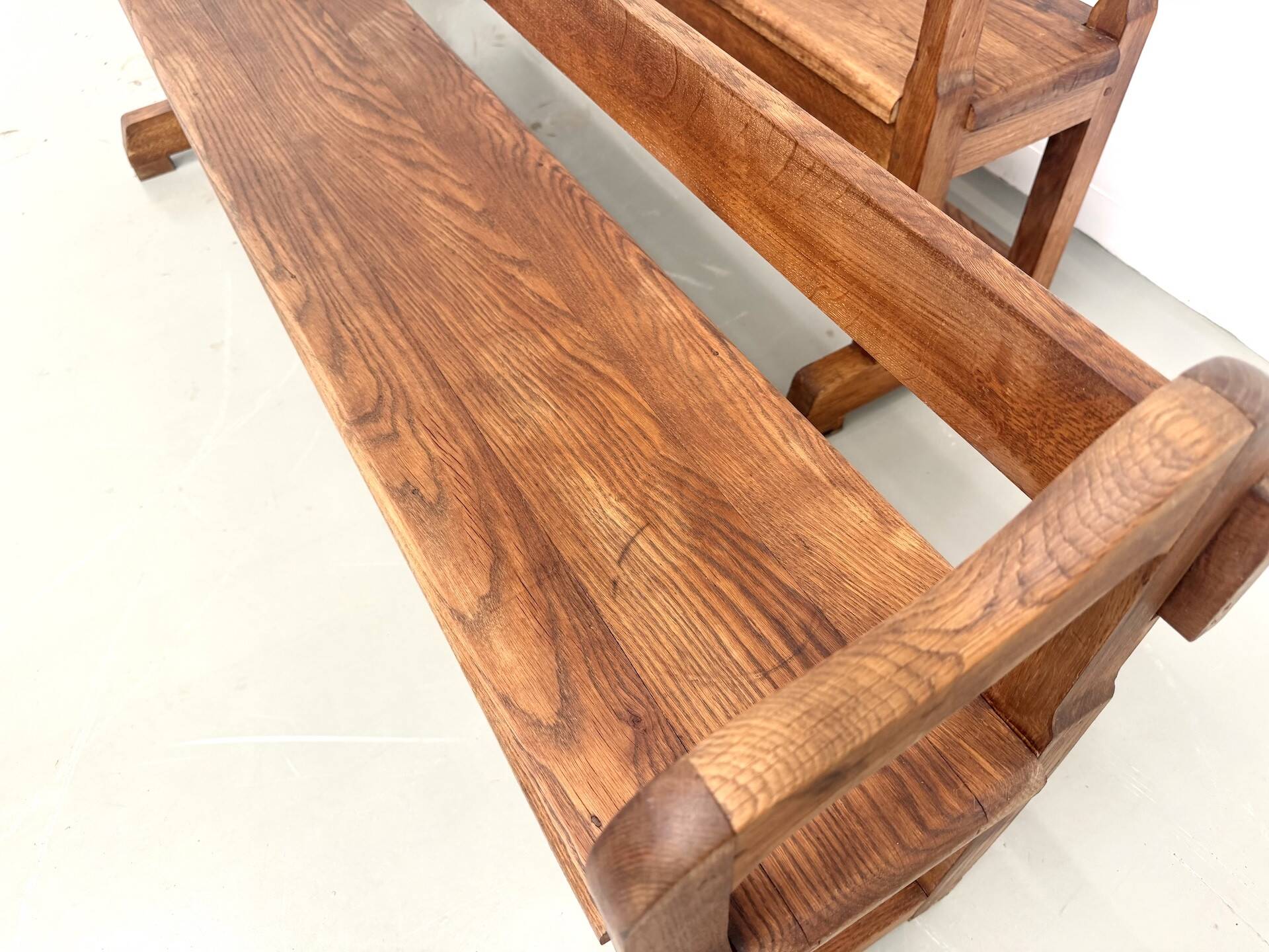 Pair of communal benches in solid oak, 1950s.