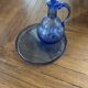 Set of a carafe with its blue glass tray.