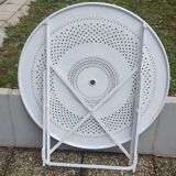 Folding round table and four wrought iron armchairs