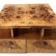 An Art Deco coffee table made of beech wood and elm burl with drawers.