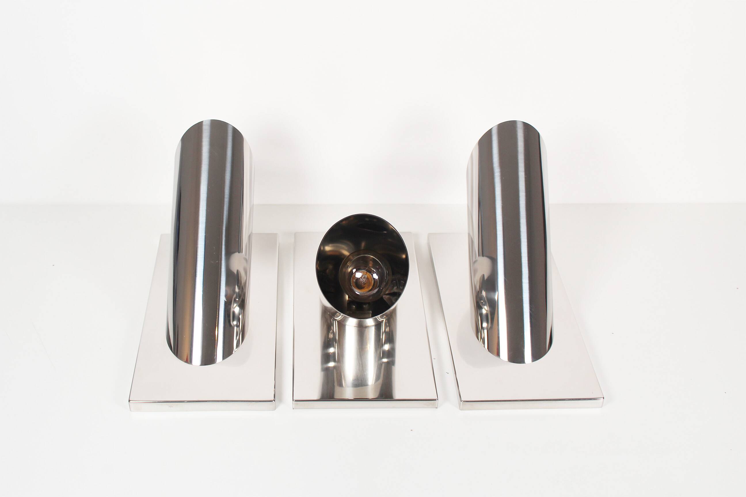Set of three large sculptural vintage chrome metal wall lights