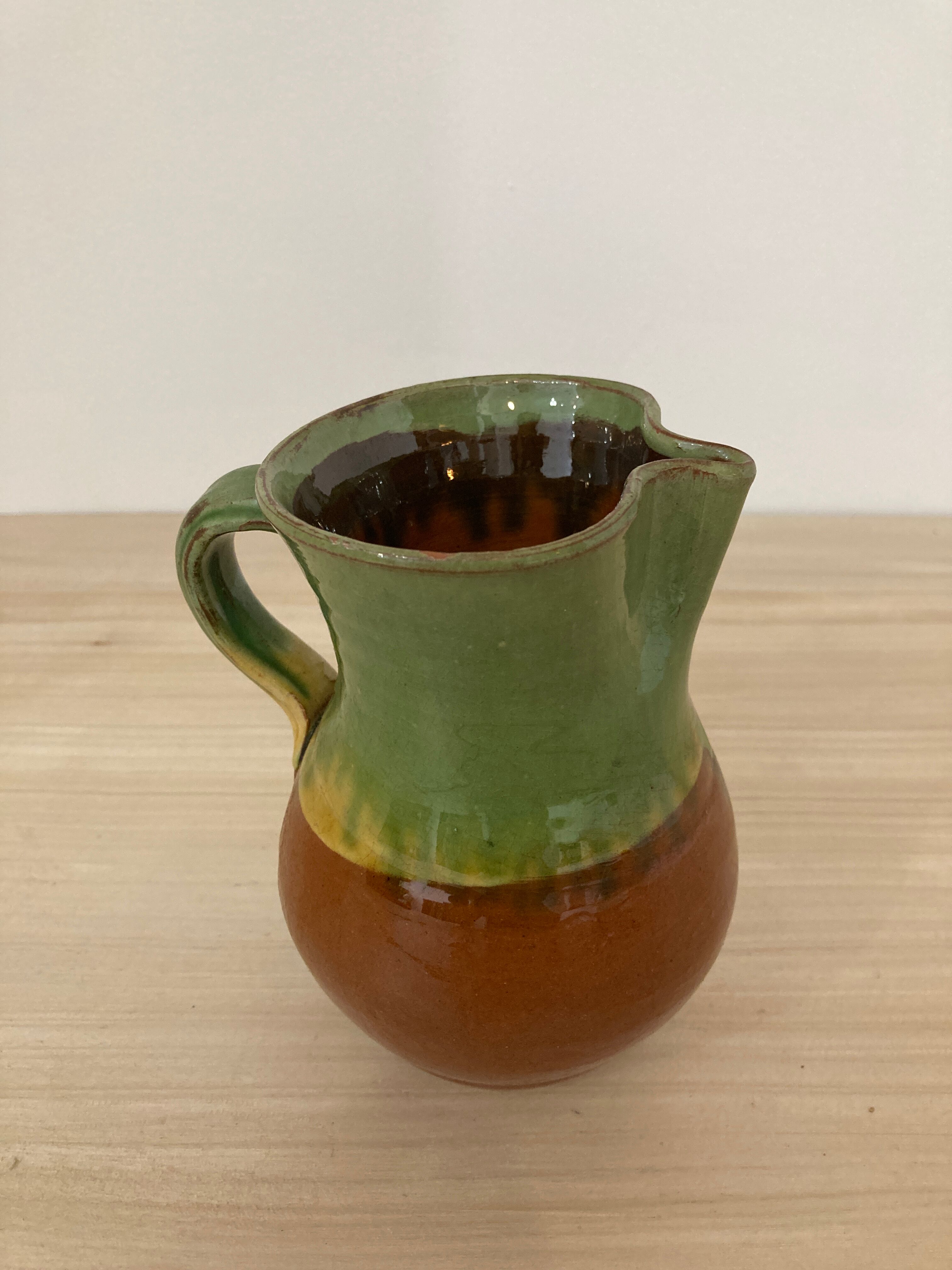 Green and brown ceramic pitcher