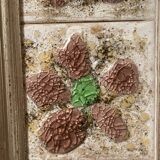 Large square ceramic mirror with floral decoration.