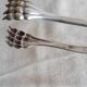 Antique silver-plated sugar tongs with lion's paws.