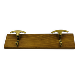 Vintage wall coat rack in brass and wood design.
