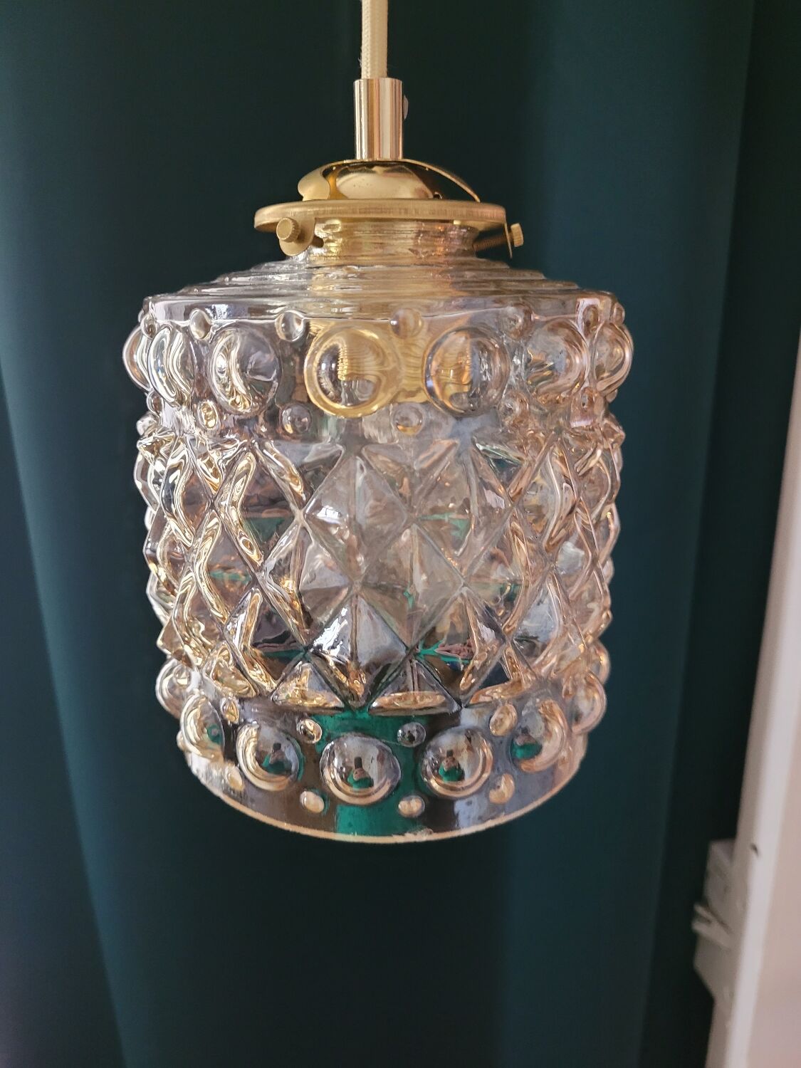 Moulded glass lamp with a cubic-spherical relief design.