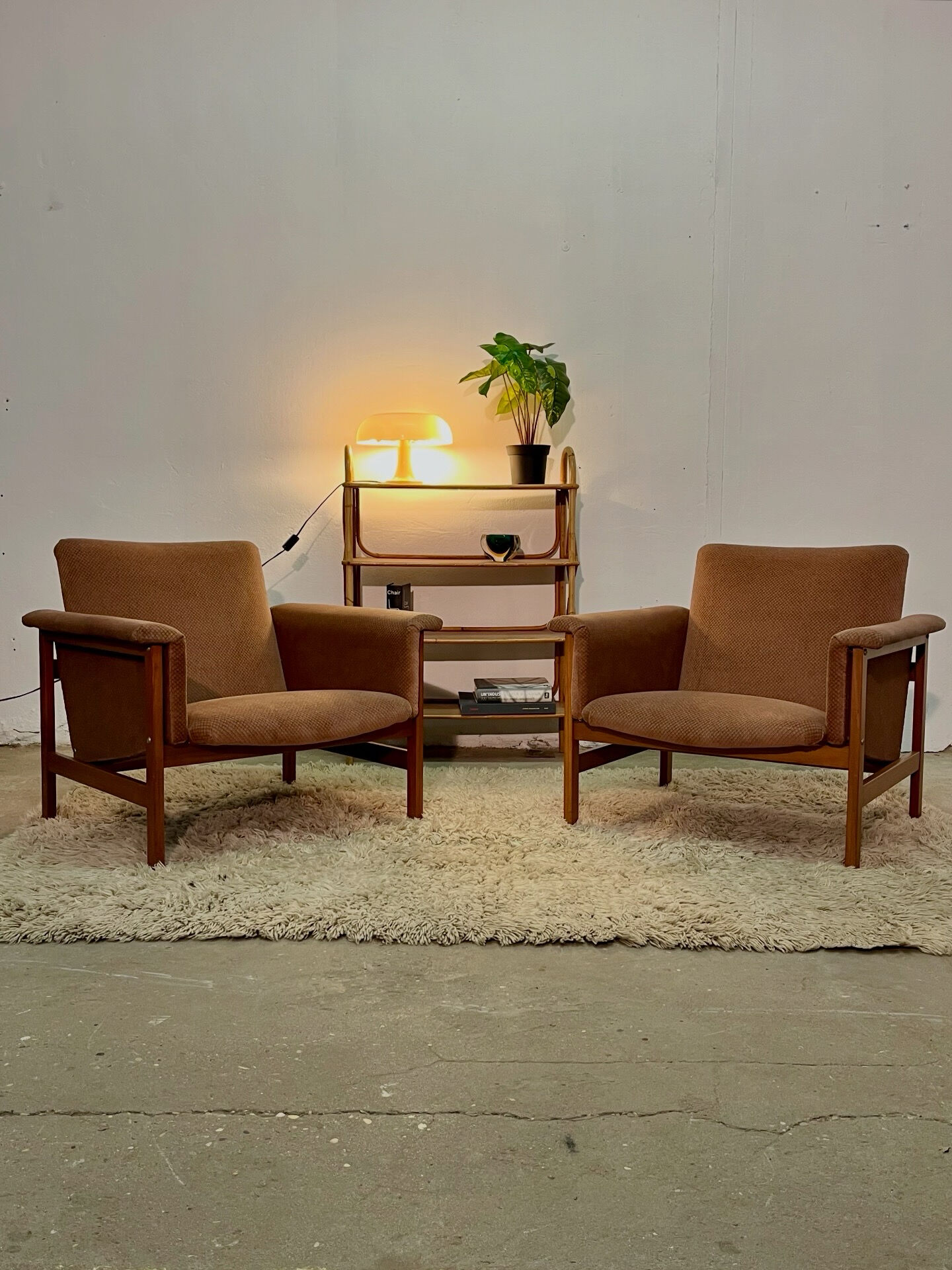 Vintage shelf on legs made of rattan and wood.