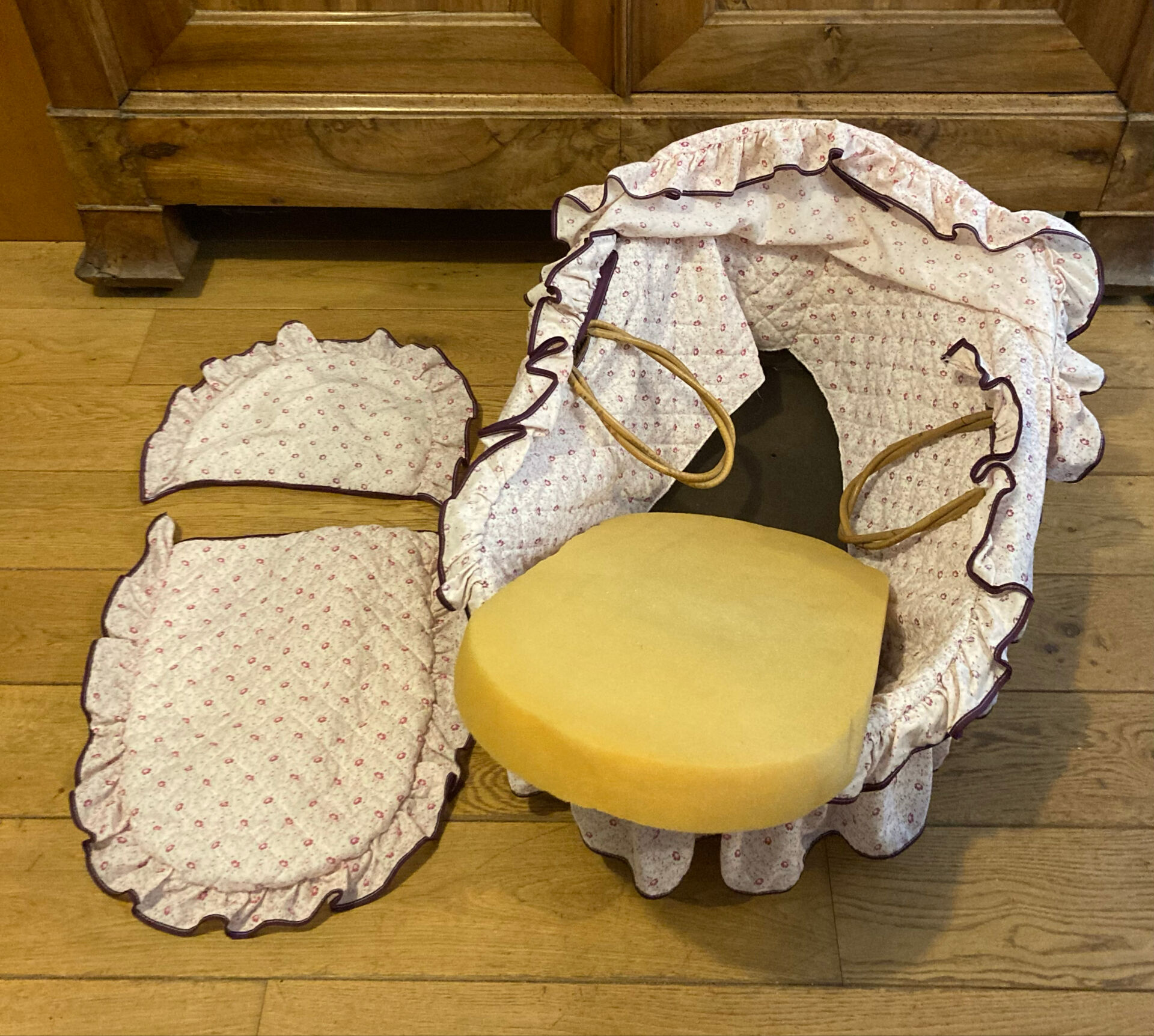 1960s wicker cradle with mattress and drapes.