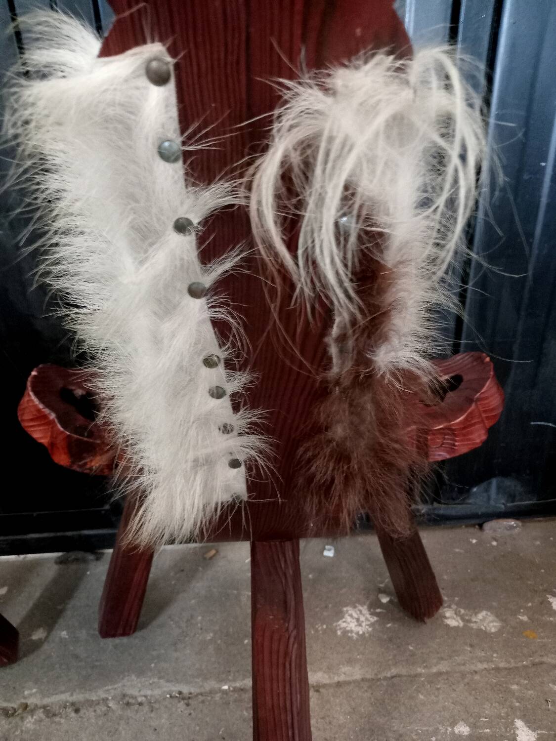 Pair of brutalist tripod chairs in wood and cowhide