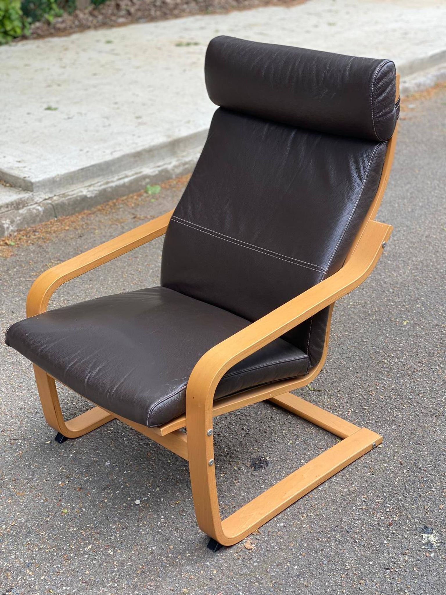 Scandinavian rocking chair in curved wood and brown leather from IKEA Poang