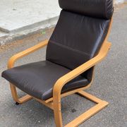 Scandinavian rocking chair in curved wood and brown leather from IKEA Poang