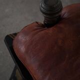 Dark red upholstered camel saddle stool, 20th century, North Africa.