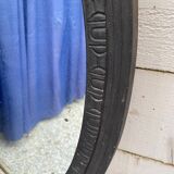 Old oval mirror with slate-coloured patina
