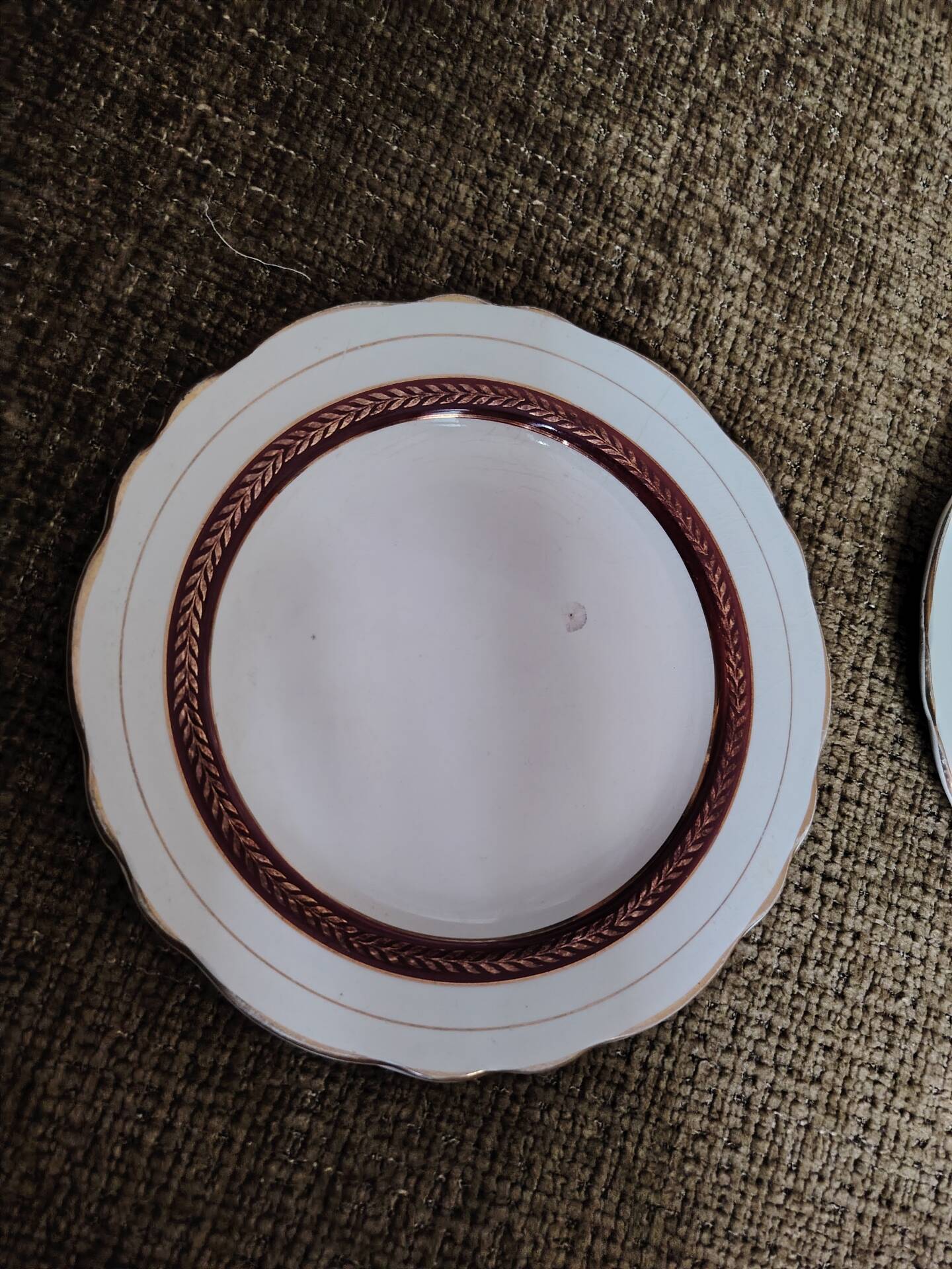 Salins white ceramic dessert plates with red trim and gold rim.