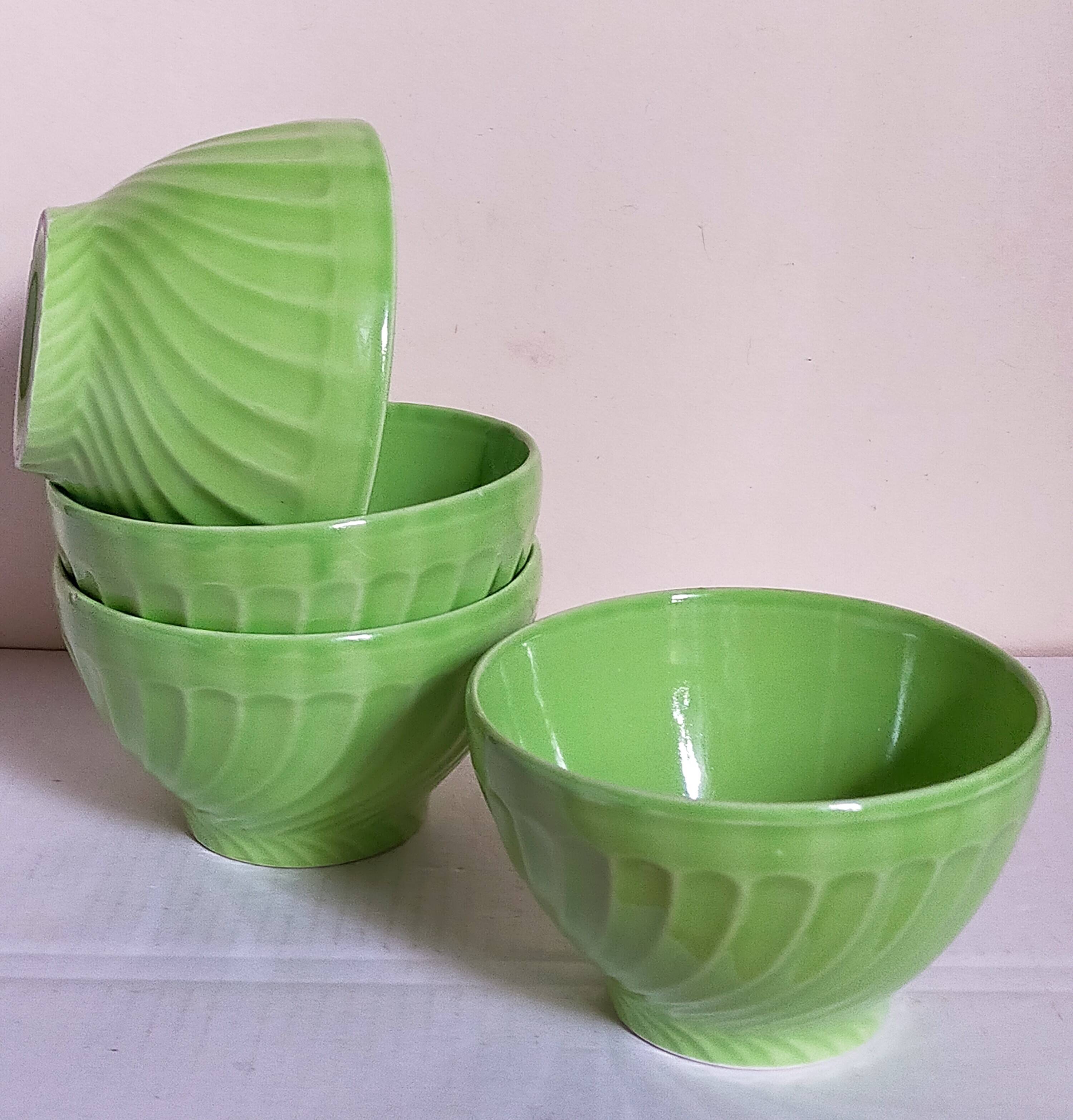 Four vintage spring green earthenware bowls