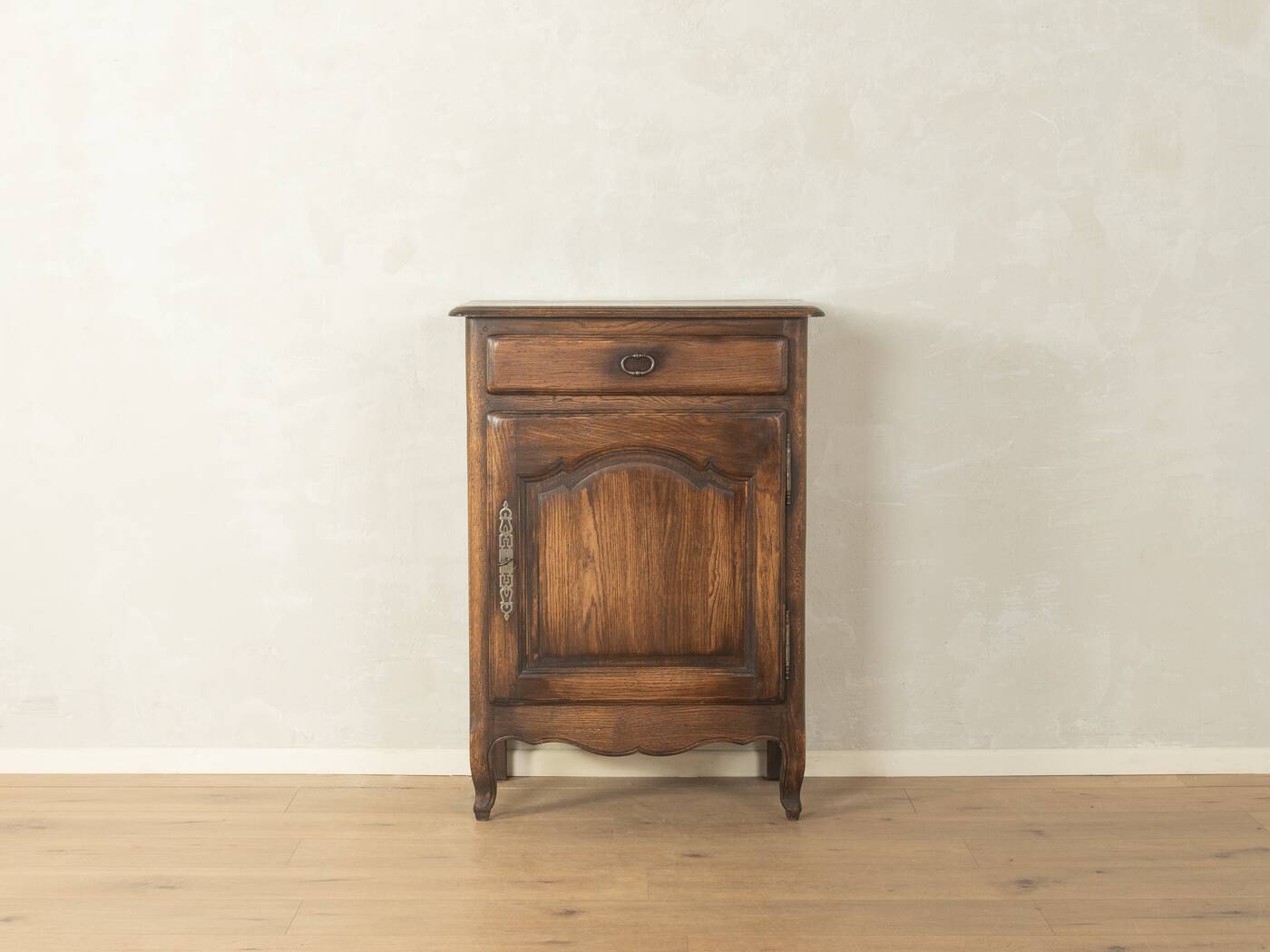 Antique chest of drawers with curved silhouette and patina