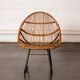 Rattan armchair with metal legs