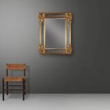 Richly decorated wall mirror in resin with golden ornaments and smoked mirror glass panels, Belgium,
