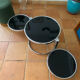 Coffee table with pivoting metal and black glass elements.