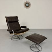 Vintage leather reclining armchair and its 1970s designer ottoman.