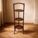 Vintage 3-tier cake stand in dark wood, 1920s serving display.