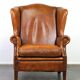 Positively lived-in sheepskin leather wing chair with pleasant seating comfort