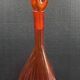 Bouteille en verre bullé orange  à panse incurvée, vers 1970