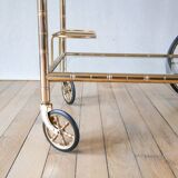 Serving table in gilded metal and glass with large wheels 1950