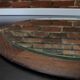 Round mirror in a vintage teak wood frame
