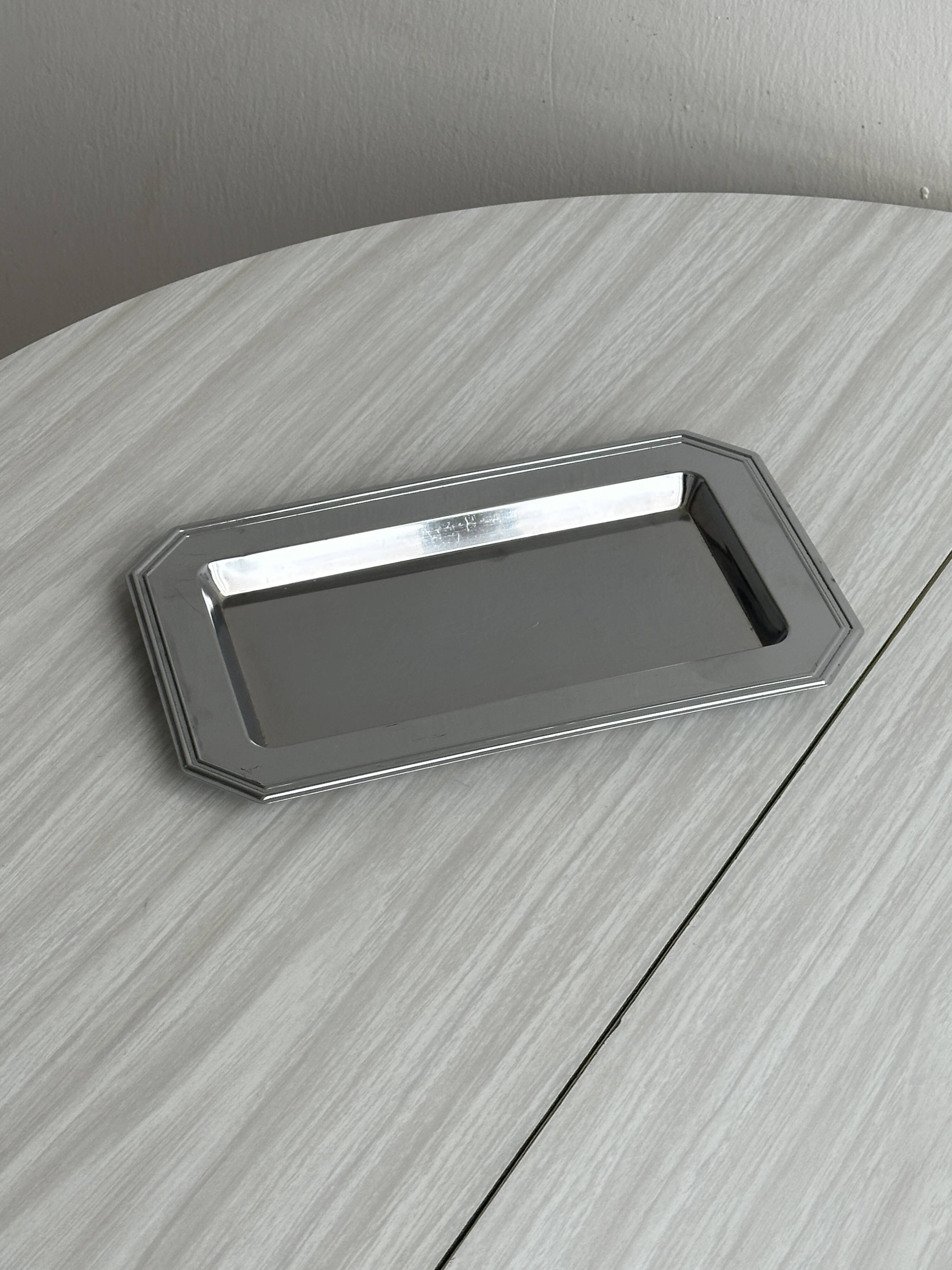 Small rectangular tray made of lightweight metal.
