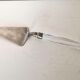 Silver metal pie shovel glass handle Lisa Mori