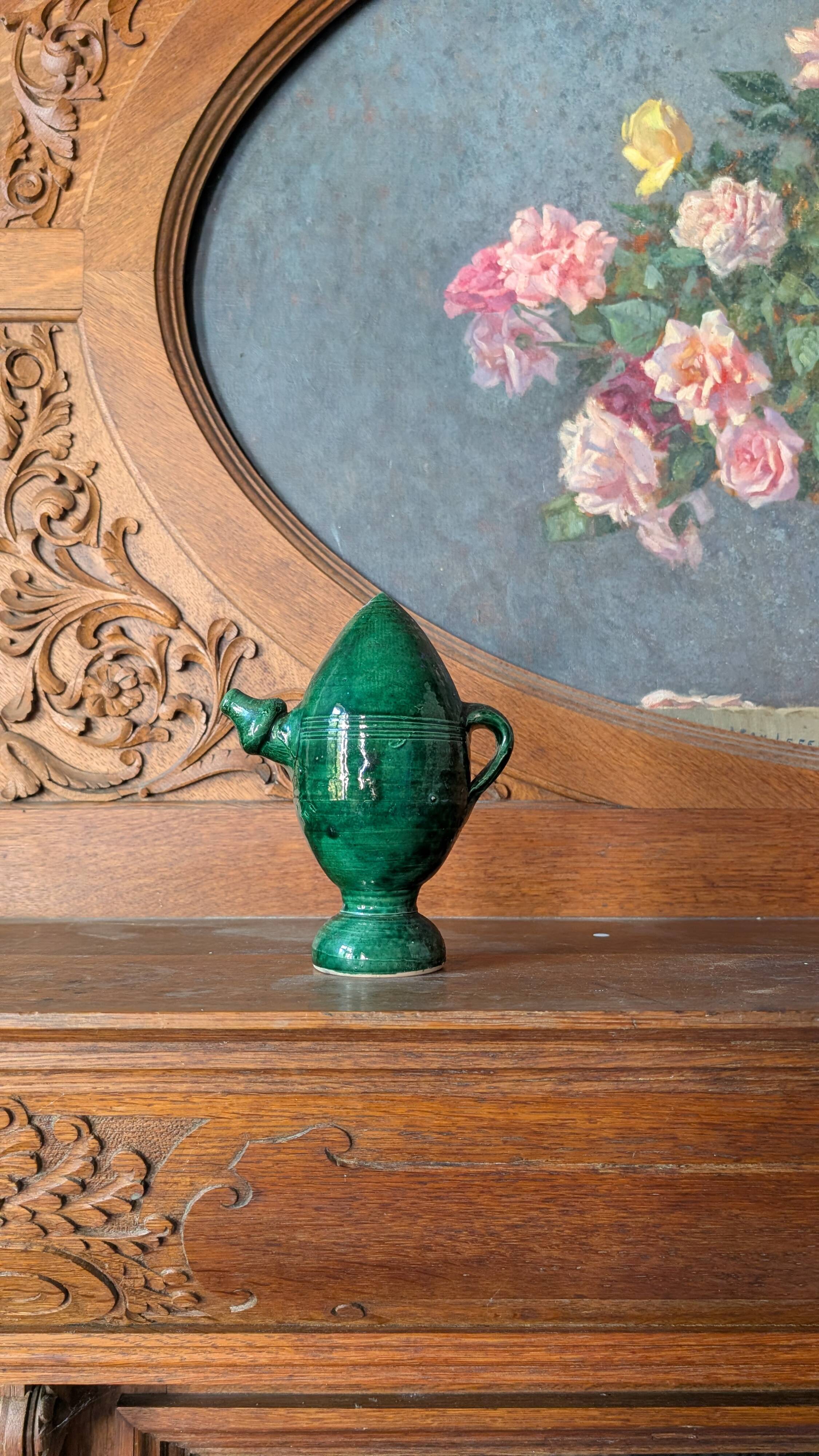Decorative piece in green glazed stoneware, jug shape.