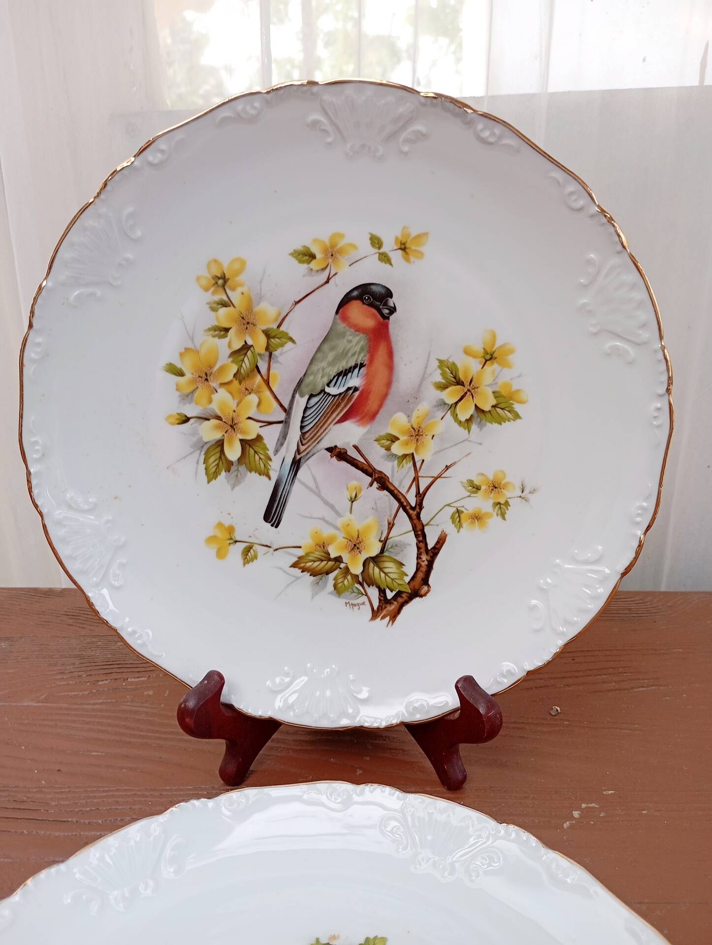 Two Limoges porcelain plates signed M. Hague.